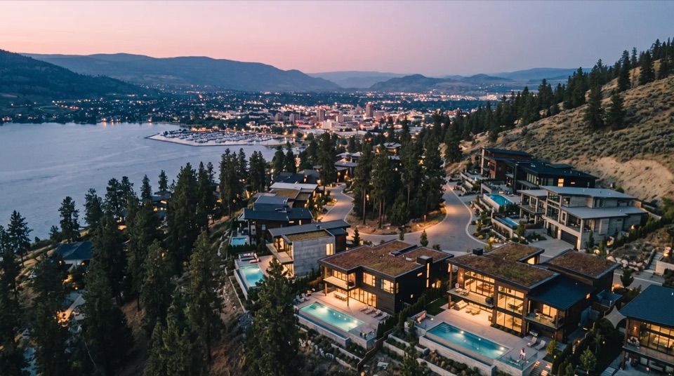 Wilden at Dusk: Forest-modern homes tucked into the ponderosas, warm windows on the hillside.