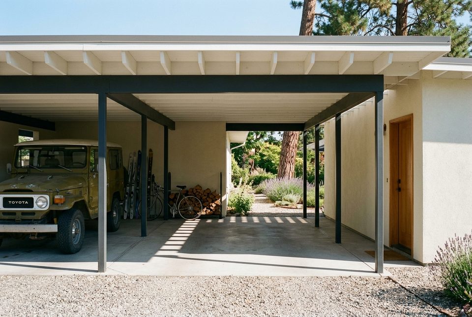 Carport, not garage. Leaving three walls off is lighter, cheaper, and you see straight through the house to the garden.